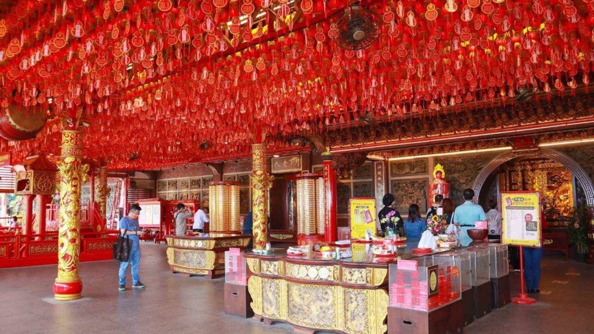 財神殿滿滿的大紅燈高掛，燈籠下方繫著信眾的祈福卡。（圖片來源：又要飛去哪！？）