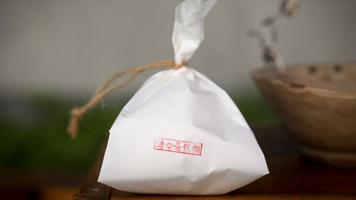 飯糰的包裝是用麻繩綁著包飯糰的紙，提在手上超可愛。（圖片來源：陳小可的吃喝玩樂）